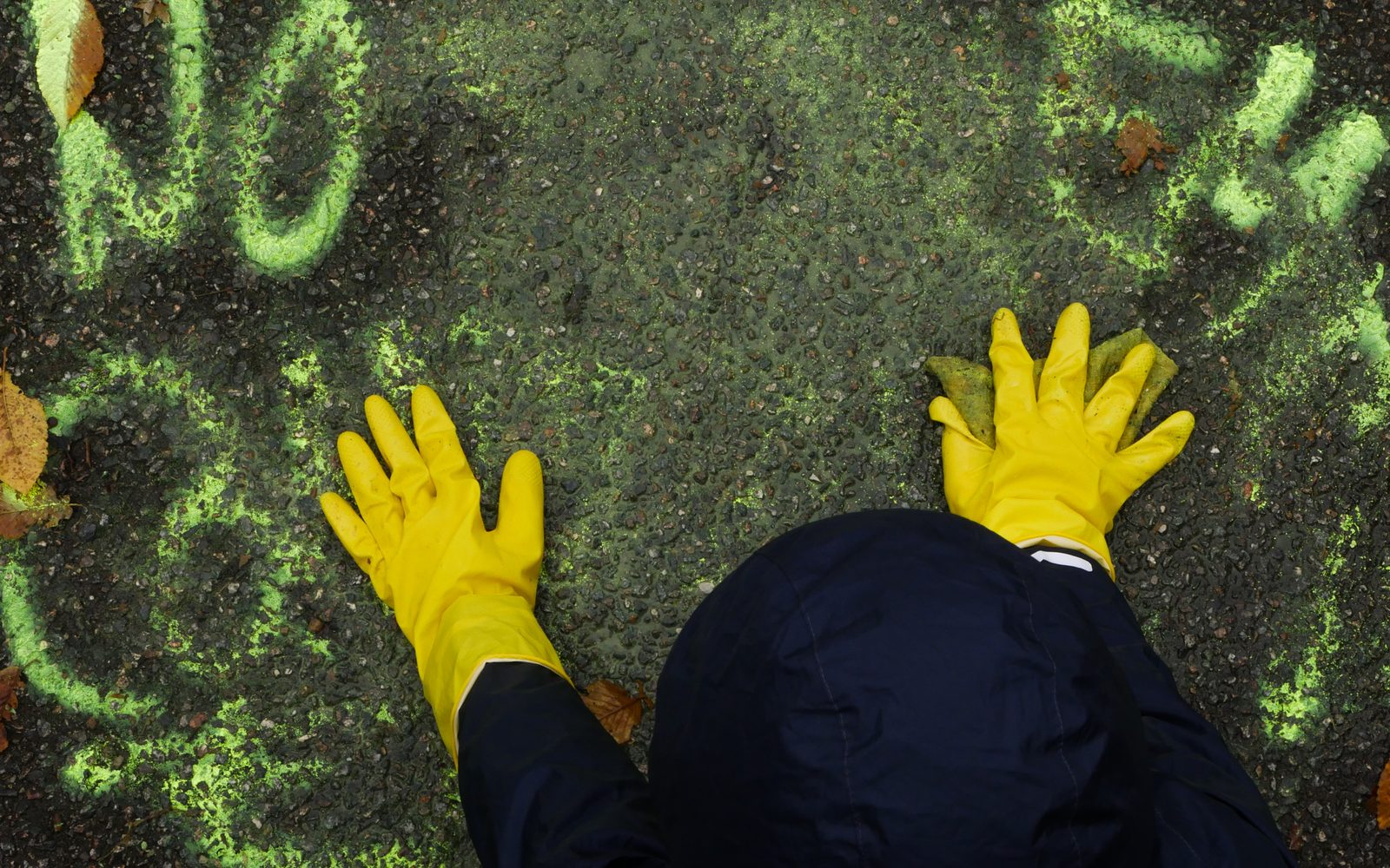 Film still: yellow gloves on a green floor