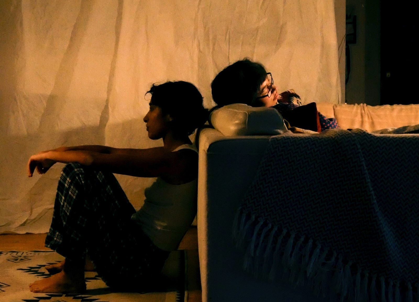 Film still: two people on a sofa