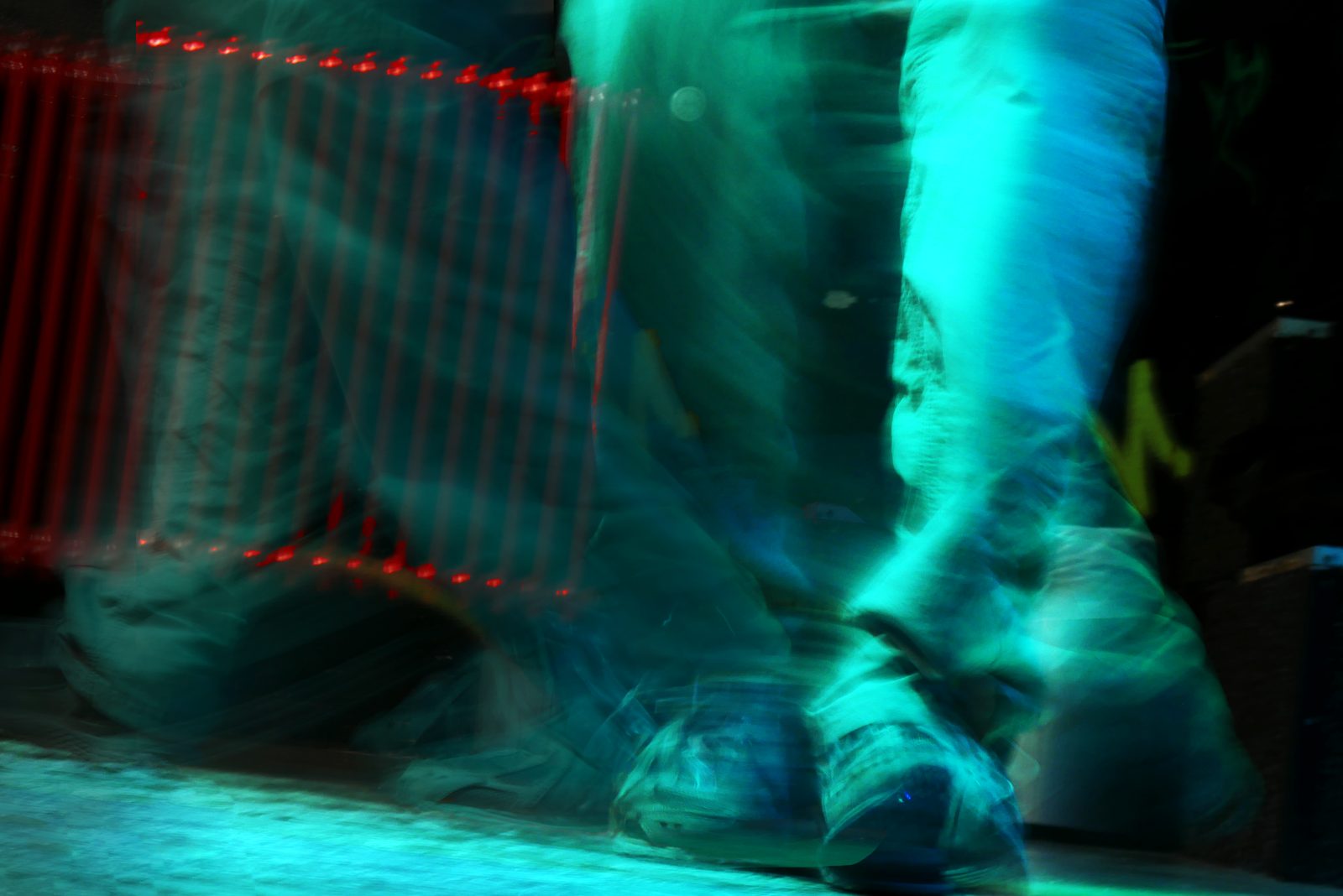 Dancing feet in teal light