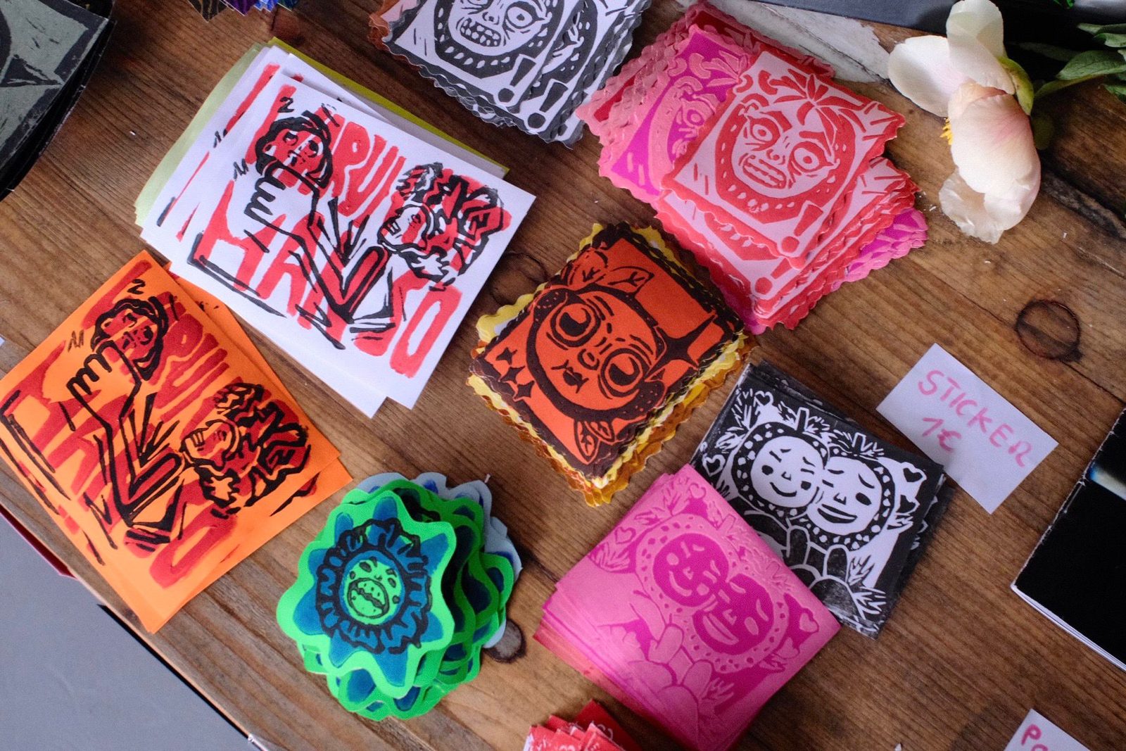 Linocut prints and charms at a market