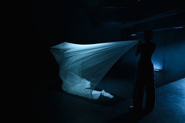 Identities: flowing fabric in blue light